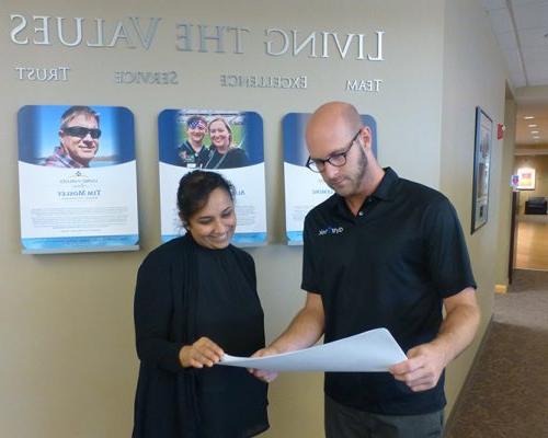 St. Louis employees discussing printed materials